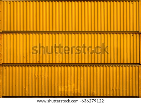 The yellow gold surface texture of the sea container. Three stacked containers without labels. Royalty-Free Stock Photo #636279122