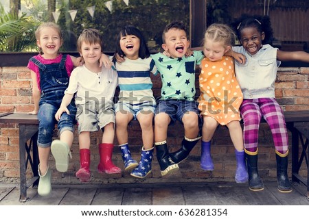 Group of kindergarten kids friends arm around sitting and smiling fun Royalty-Free Stock Photo #636281354