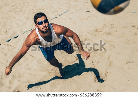Beach volleyball Player about to hit the ball