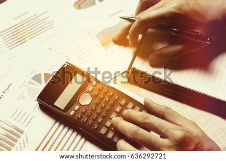 Woman calculate finance on desk with analyzing summary report at home office.