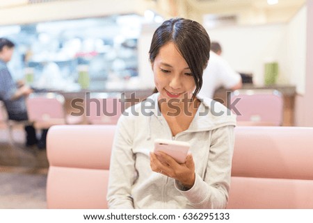 Woman using cellphone for online