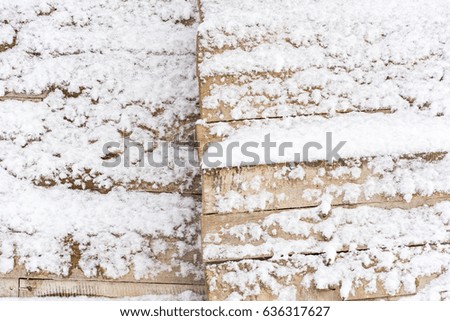 Snow drift on wood boards with blank space or room for copy, text or your words. Horizontal texture. Pile of snow with old wooden planks background. Free space for text.