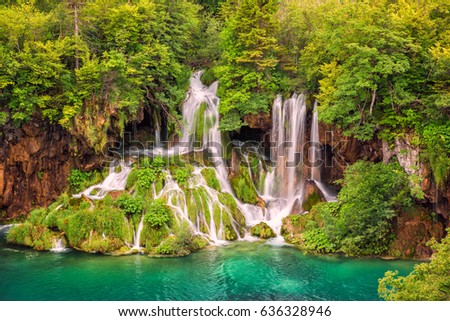 Beautiful waterfall in a green forest, Plitvice Lakes National Park, famous tourist destination in Croatia, nature background suitable for wallpaper, cover or guide book