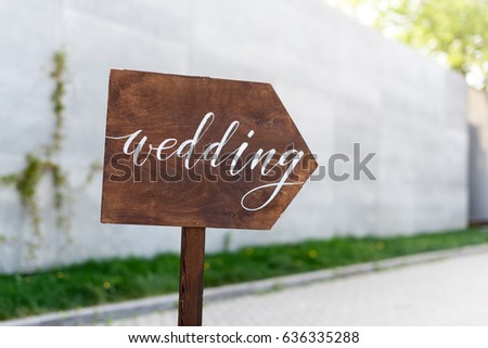Wedding decor. Wooden plaque with the inscription in paint Wedding. Wood hand made signboard, welcome wedding decoration
