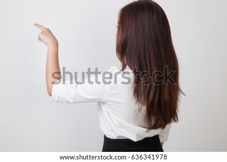 Back of Asian woman touching the screen with her finger on white background