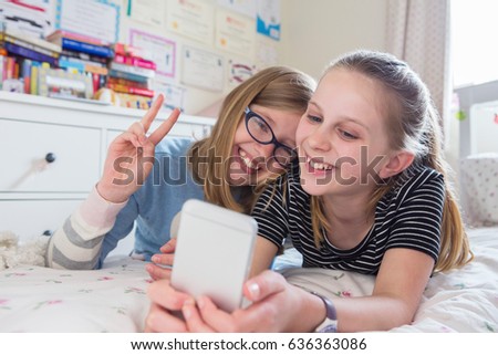 Two Young Girls Posing For Selfie In Bedroom