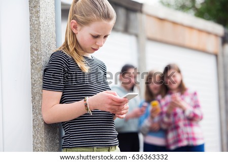 Pre Teen Girl Being Bullied By Text Message Royalty-Free Stock Photo #636363332