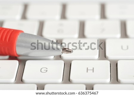 A pen and computer keyboard