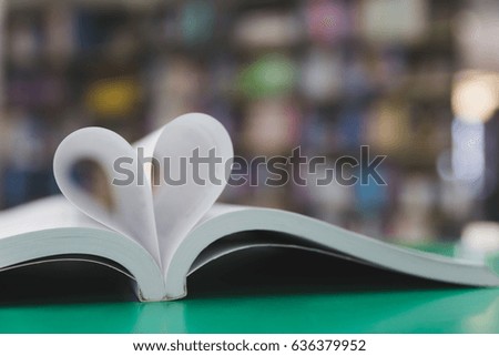 open book page in heart shape with library background, love in valentine day concept