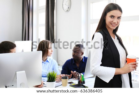 business woman with her staff, people group in background at modern bright office