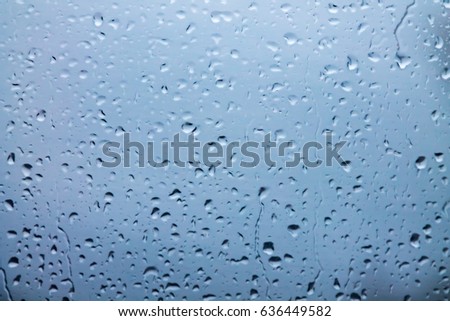 Raindrops on the fogged glass (light blue tint)