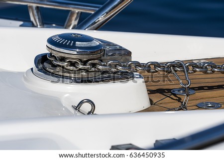 The nose of a yacht with an anchor.