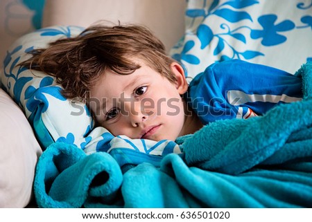 Sick child lying on couch at home having fever feeling ill. Getting well of flu.
Kid with runny nose and sore throat Royalty-Free Stock Photo #636501020