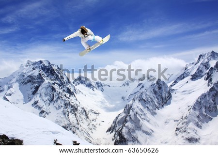flying snowboarder on mountains Royalty-Free Stock Photo #63650626