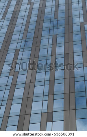 Glass window building exterior. Generic unrecognizable modern office or apartment building. Vertical frame establishing shot.