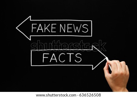 Hand sketching Fake News or Facts concept with white chalk on blackboard.  Royalty-Free Stock Photo #636526508