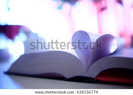 book pages heart background blurred