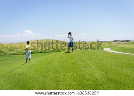 Happy summer vacation for kids on green meadow near sea