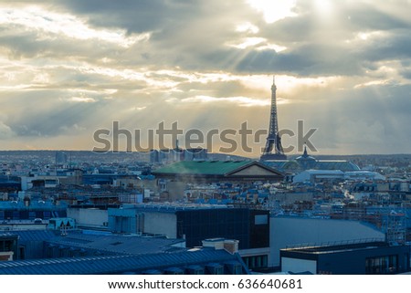 Aerial view of the Eiffel tower, Paris symbol and iconic landmark. Panorama of the Paris skyline with roofs on a cloudy day. Famous touristic places and romantic travel destinations in Europe. Toned