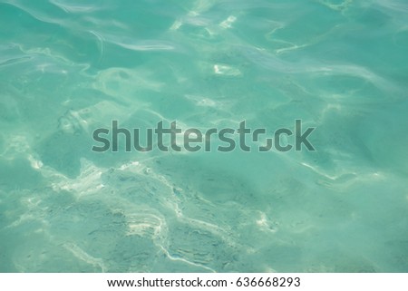 Turquose waters under sunlight create beautiful background and texture