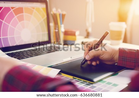 Digital art graphic design adviser consulting with young designer at the classroom, using a  stylus pen tablets by Photographer drawing and retouching image on laptop computer,Vintage tone Royalty-Free Stock Photo #636680881