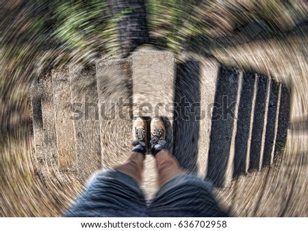 Hiker in boots at top of dual staircase with radial spin, concept image