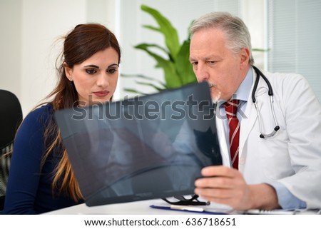Doctor showing a knee radiography to a patient