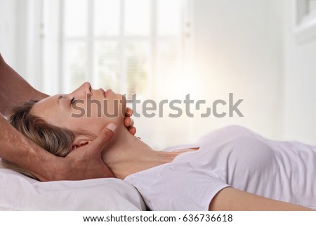 Woman having chiropractic back and neck adjustment. Osteopathy, Acupressure, Alternative medicine, pain relief concept. Craniosacral therapy Royalty-Free Stock Photo #636736618