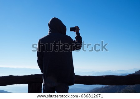 young man traveler enjoy taking  photo with mobile phone