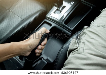 Driver pulling the hand brake in car for brake or drift for race.