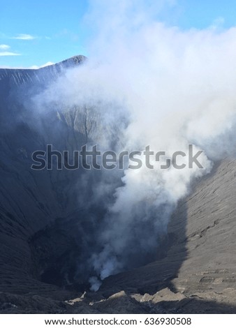 Smoke from Bromo's crater in sunshine day.