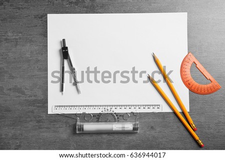 White paper and engineer supplies on table