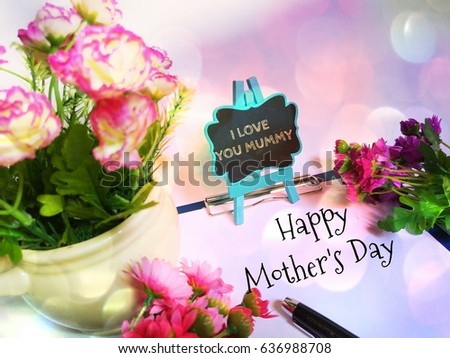Happy Mother's Day concept image with background of flowers and a message of i love you mummy. 