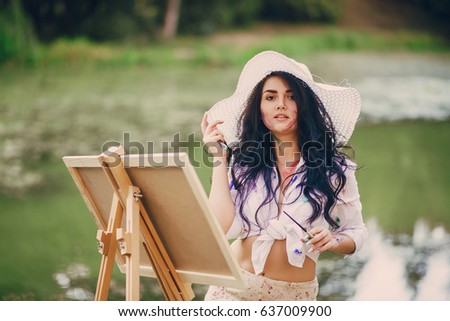 artist girl walks in the park. draws a picture. and resting