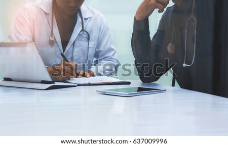 Medicine doctors working with computer notebook and digital tablet  at desk in the hospital. Medical teamwork discussion