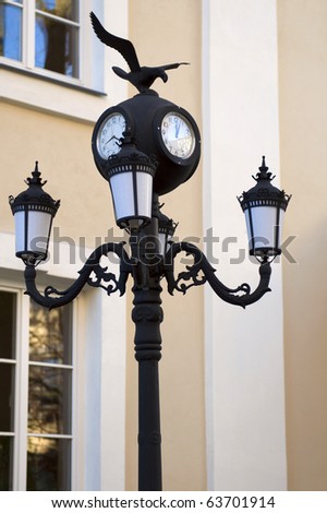 Old street lamppost witha clock. Vilnius. Lithuania.