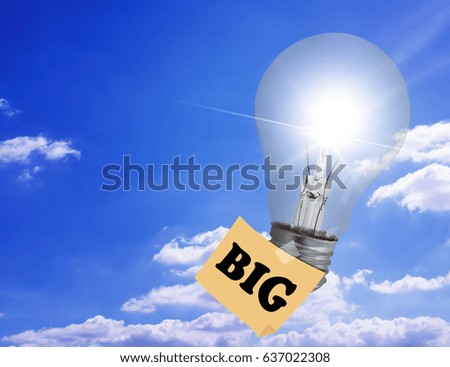 Think big concept, light bulb fly on blue sky background