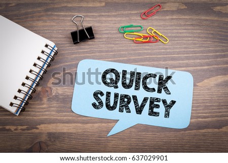 Quick Survey. Speech Bubble on a dark textured wooden background