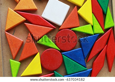 Colorful geometric shapes on a brown background.
