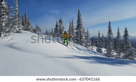 Snowboarding rider in mountains with snow, blue sky winter landscape, Russia