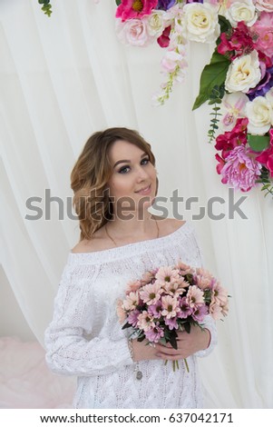 Portrait of a beautiful girl on a background of flowers