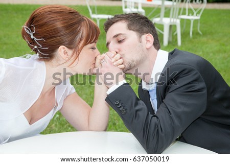 bride and groom arm wrestling