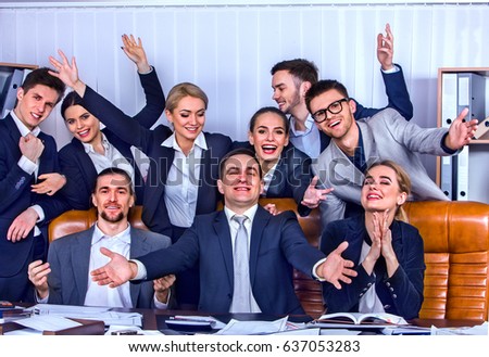 Business people office life of team people with hand up celebrate successful signing of contract. Cabinets with folders and jalousie background. Business team is happy from having won a business deal.