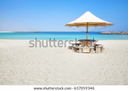 Beautiful beach with sun umbrella, summer holidays concept picture with copy space.