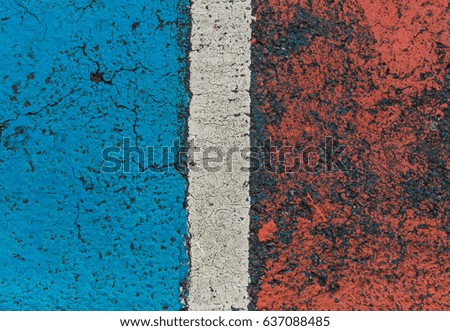Blue, white and red painted road tarmac grunge background