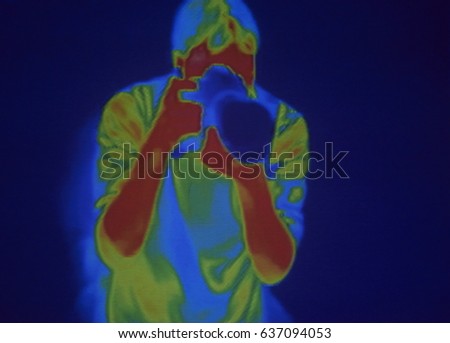 Thermographic image of the photographer (Paparazzi). Photo showing different temperatures in range of colors, blue showing cold, red showing hot which can indicate joint inflammation