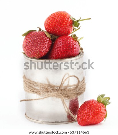 Strawberries fresh and red lays in the pot next to the paraphernalia