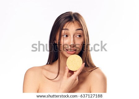 beautiful woman portrait on yellow background with sponge                   