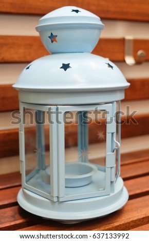 Decorative Light Blue Vintage Lantern on A Wooden Table, Used to Illuminate Surrounding Space for Decorations and Atmosphere.