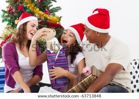 happy family opening Christmas gift at home